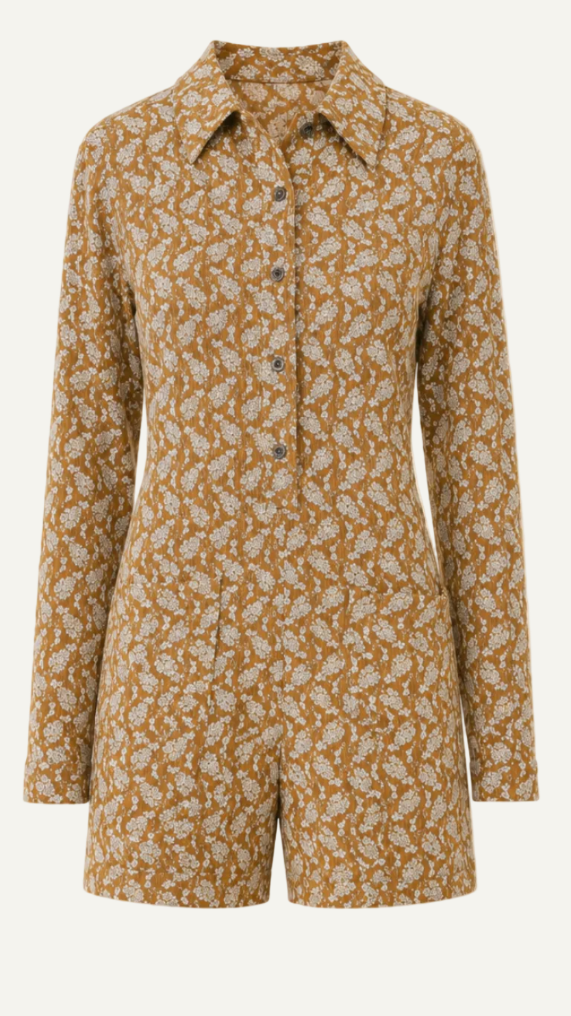 A long-sleeve collared romper with an all-over floral print in brown and beige, displayed on a solid light beige background.