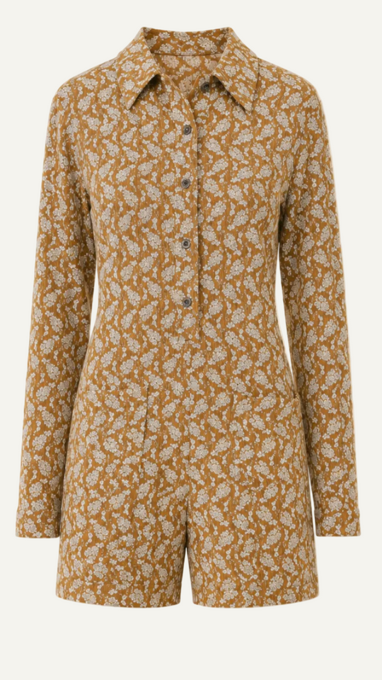 A long-sleeve collared romper with an all-over floral print in brown and beige, displayed on a solid light beige background.